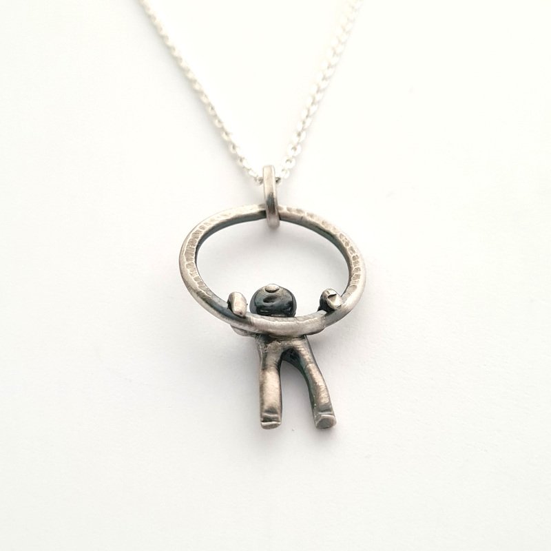 Small Hammered Ring With Little Man Hanging