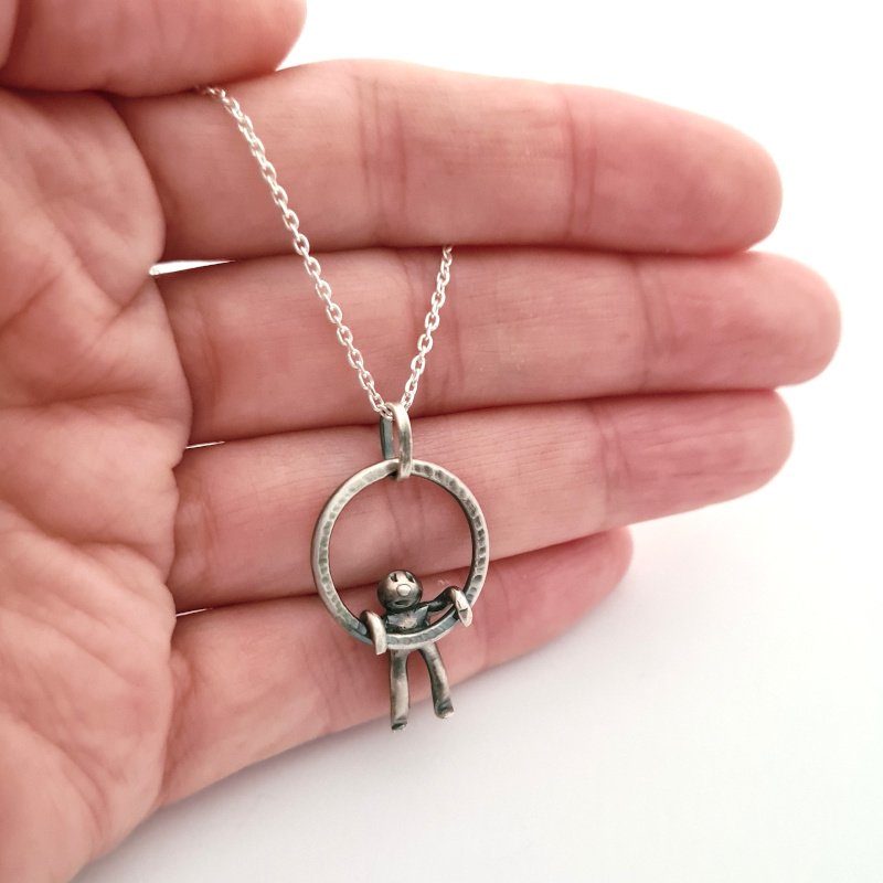 Small Hammered Ring With Little Man Hanging