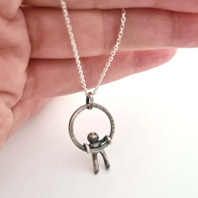 Small Hammered Ring With Little Man Hanging
