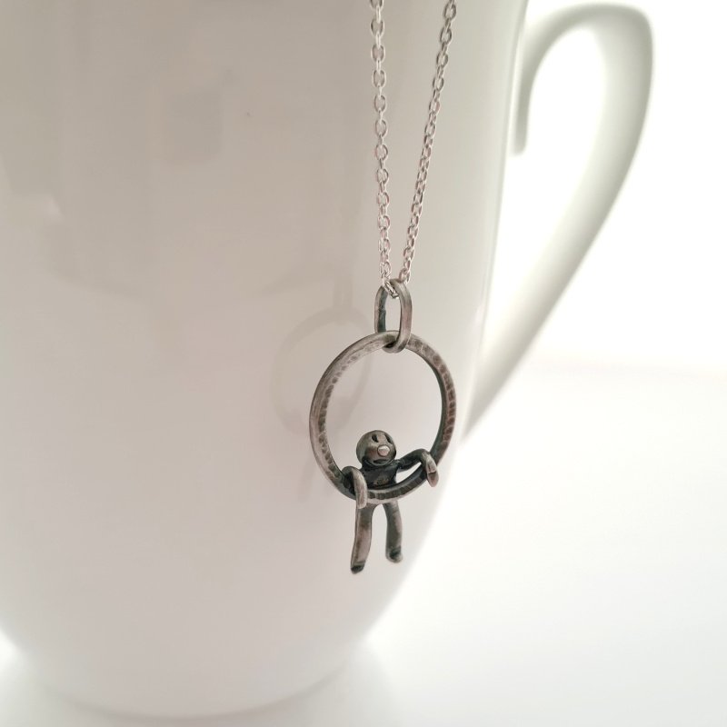 Small Hammered Ring With Little Man Hanging