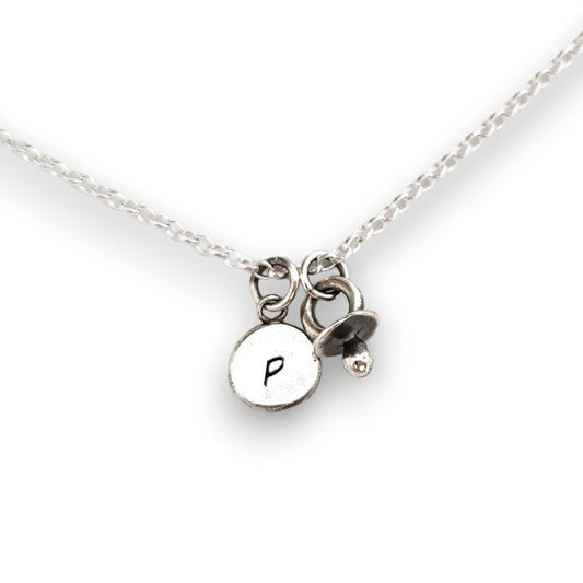Initial silver disc pendant with baby dummy charm